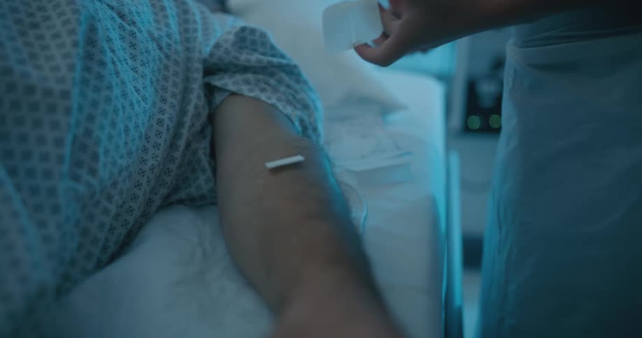 A nurse tending to a patient in a hospital bed