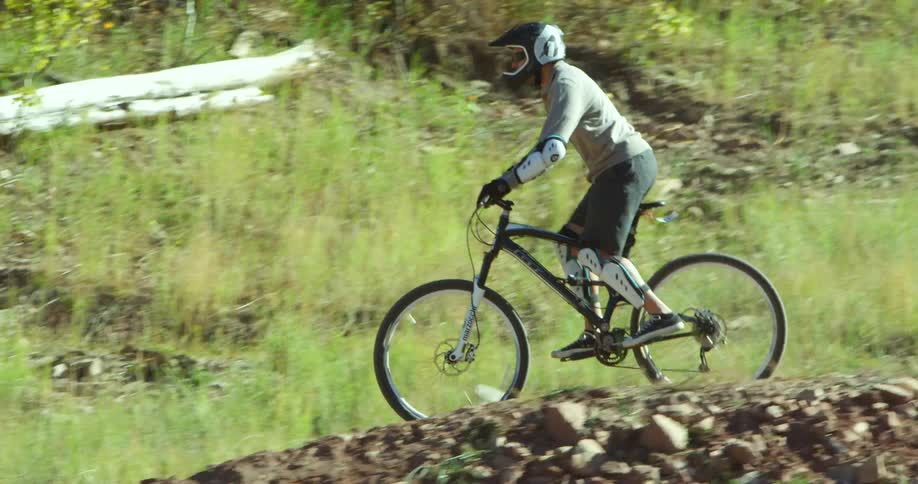 Cyclist rides a cross country mountain bicycle on a dirt track
