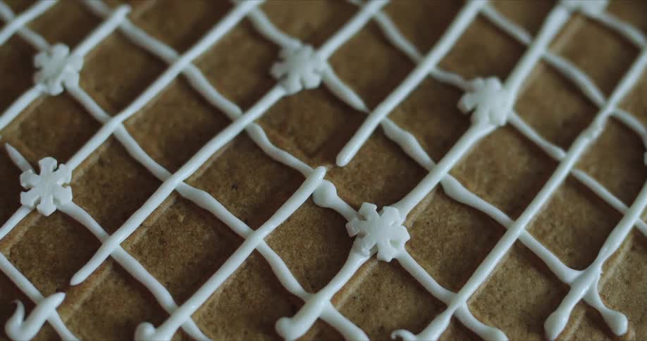 White brown and black colors that look like a dessert with a white frosting grid