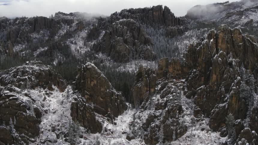 Aerial view of the snow covered peaks of a mountain range