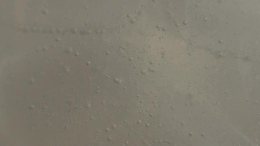 A while or clear liquid and solid with bubbles