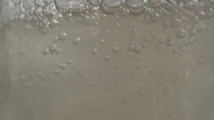 Close up of sparkling beverage filling a glass