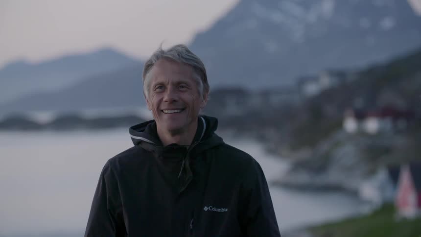 A man is smiling as he looks forward