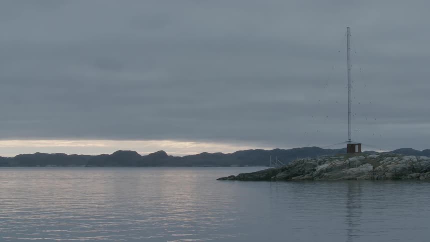 Body of water under a cloudy sky