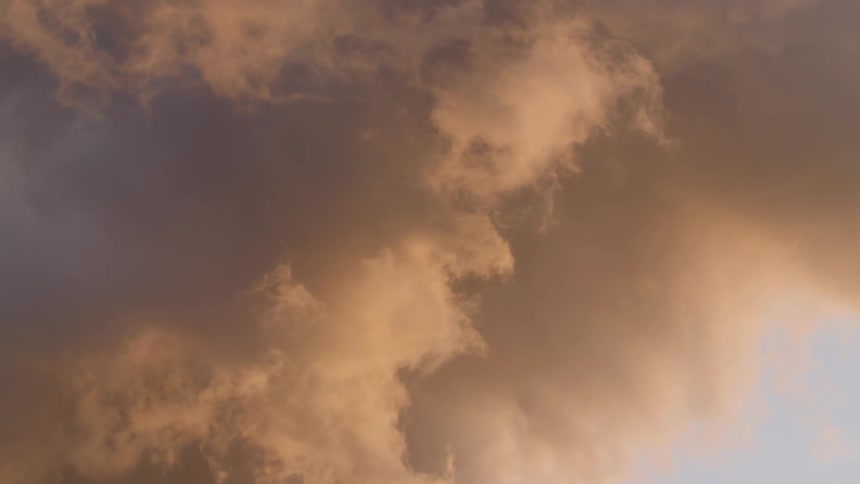 A skyline has large clouds moving around