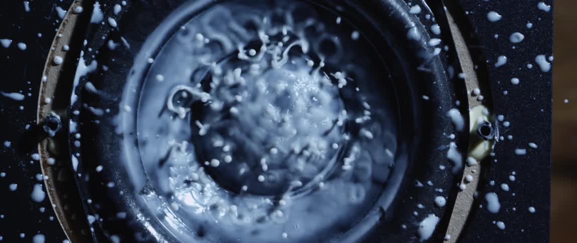 A birds eye view of liquid boiling and splashing on a cook top