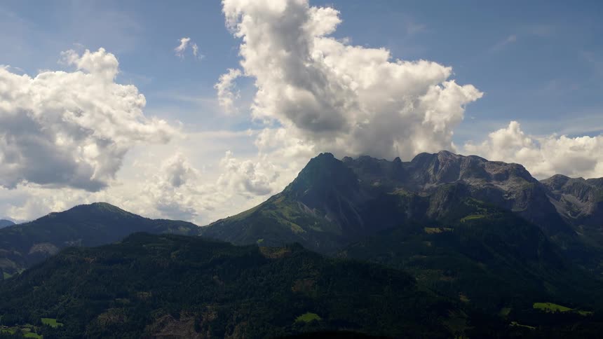 Rolling clouds moving over a mountain range