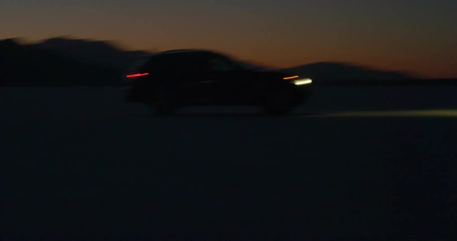 A car driving on a street at night