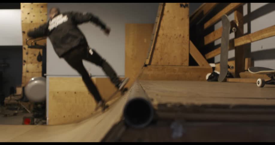 A person is skateboarding indoors