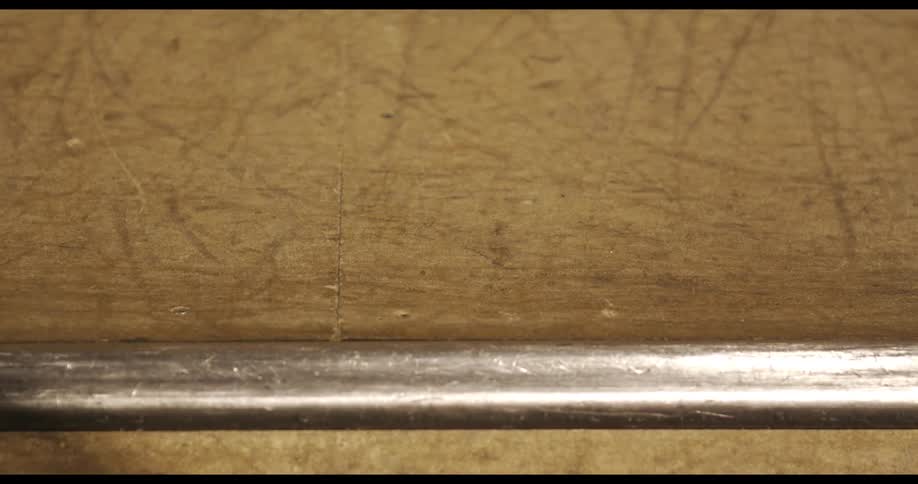 A skateboard moves down a step with a metal peace