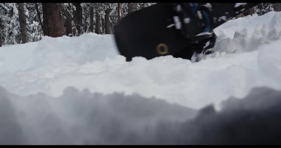 A person is snowboarding outdoors in winter