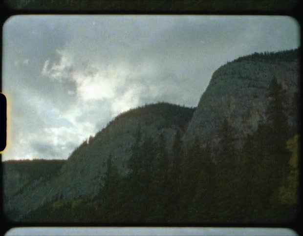 Storm clouds above a mountain and trees
