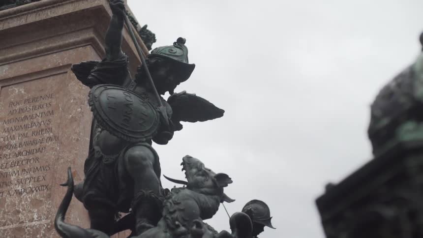 A statue in front of a monument