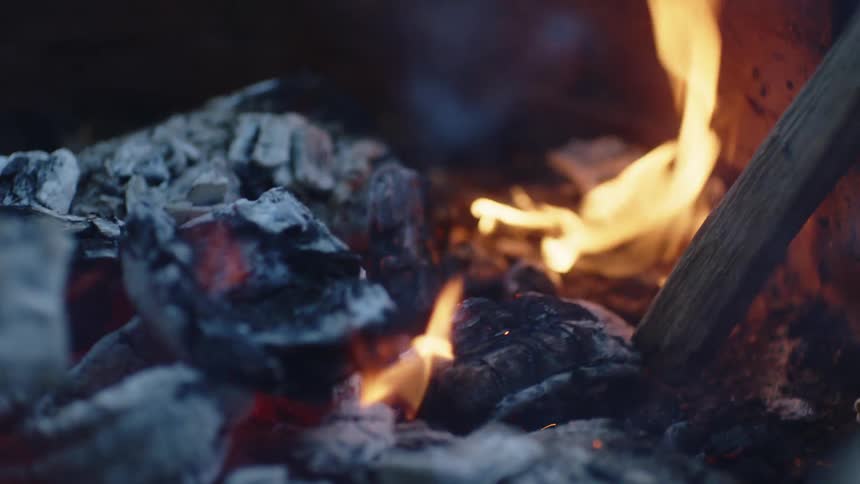 A person is by a bonfire outdoors