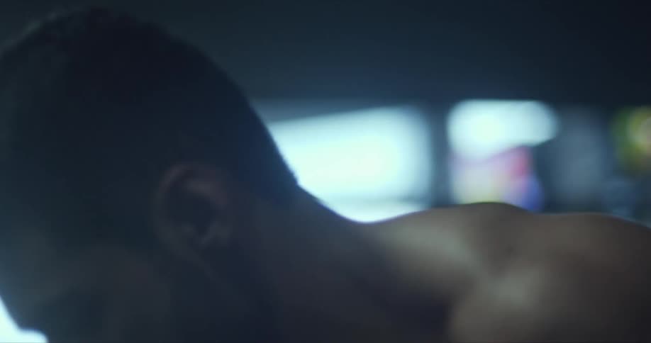 A man is exercising in a gym during the day