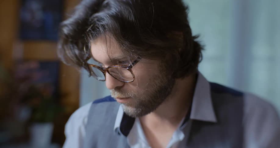 A man looks down as he reads