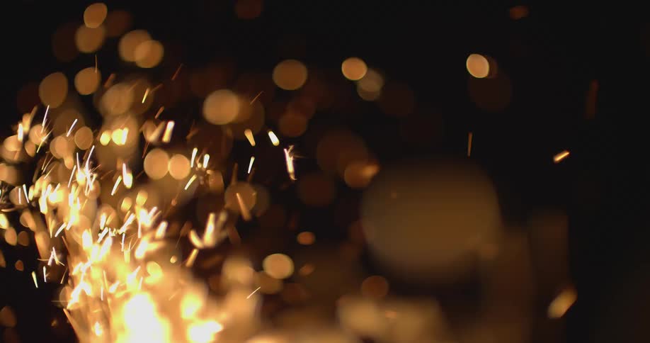 In a darkened setting a constant flurry of sparks are launched upwards