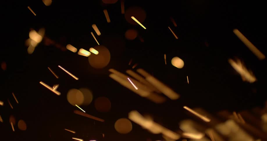 Yellow firework sparklers flicker off to the left