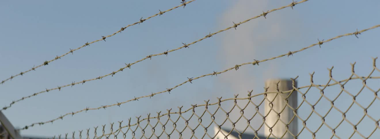 Chain link fence with barbed wire across the top