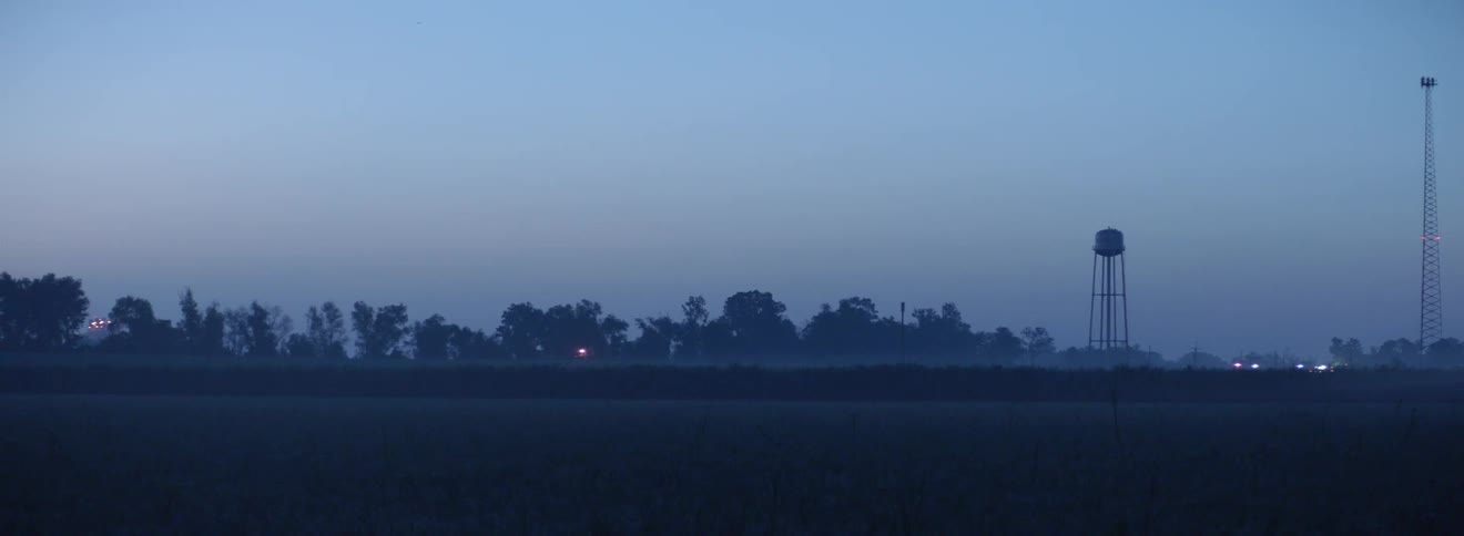 The sun is setting in a rural area