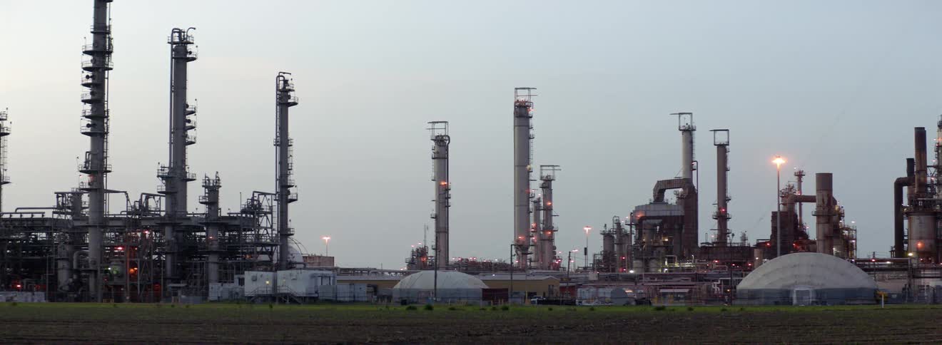 An industrial area with low structures with grass in the front