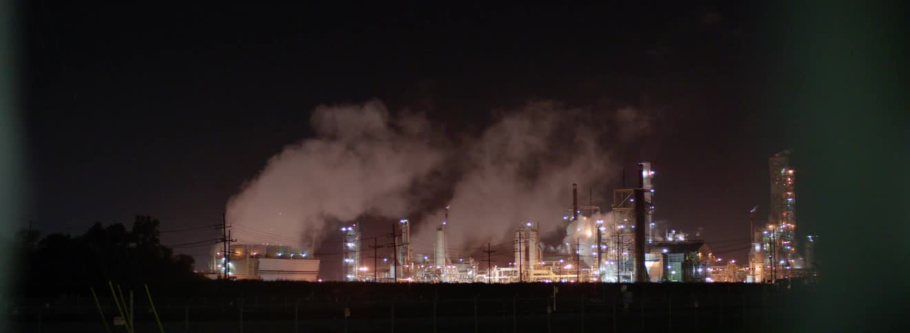 Lights shining on an industrial complex at night