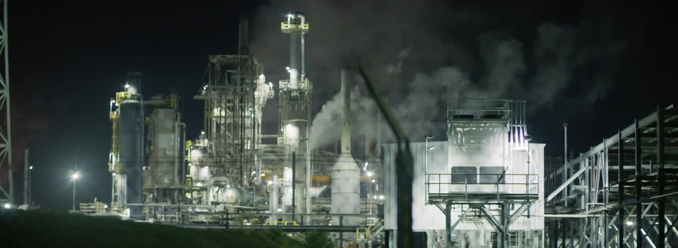Lights and smoke on a big industrial complex at night
