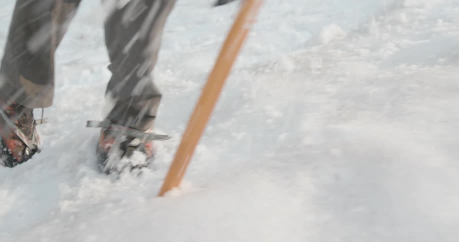 A man is hiking through an arctic area