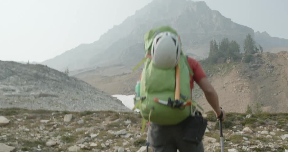 A man hiking towards a mountain
