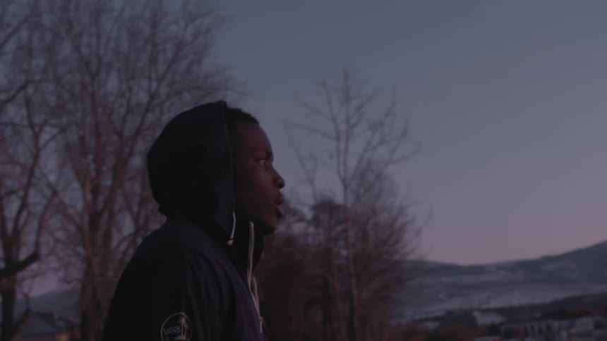 Man walks outside at dusk