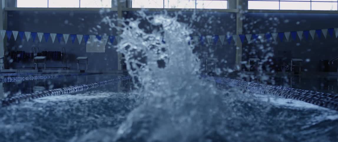 A person is diving into a pool of water