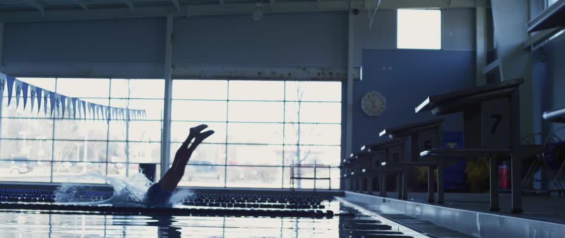 A man dives into the pool