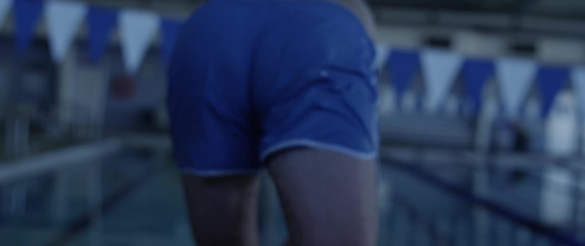 A man is diving into a pool