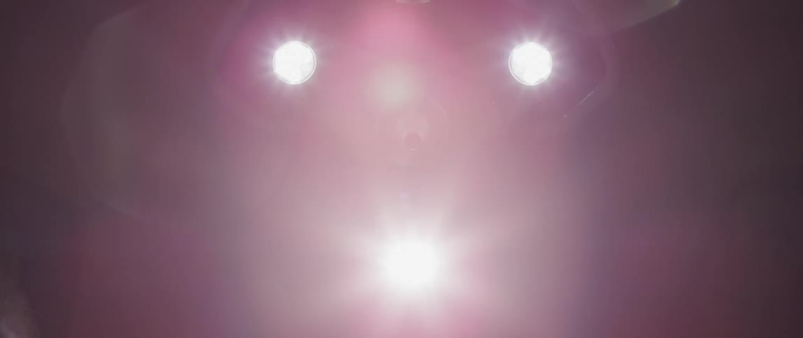 Bright lights from an overhead lamp create flares until it goes out