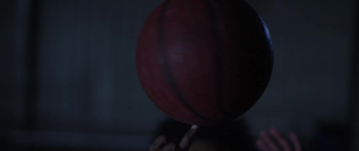 A man is spinning a basketball