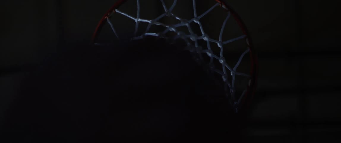 Basketball bounces off rim and enters through the net