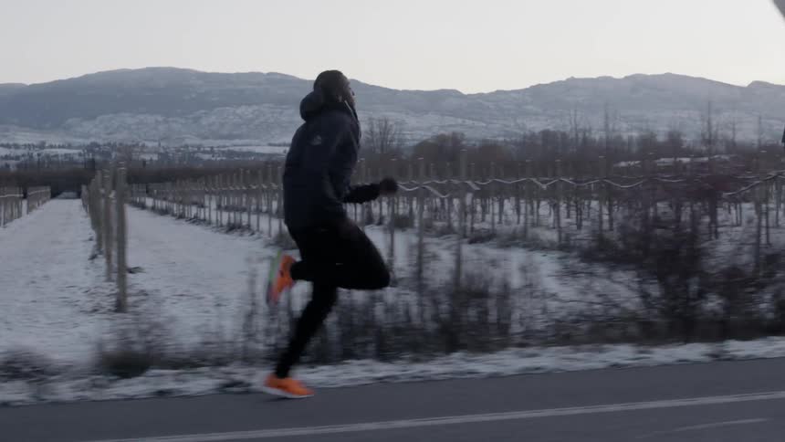 Man running down a wintry road