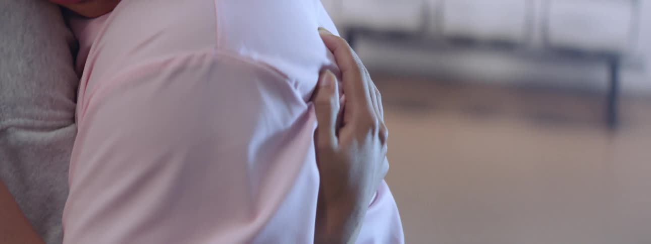 Close up of nurse hugging in a hospital room