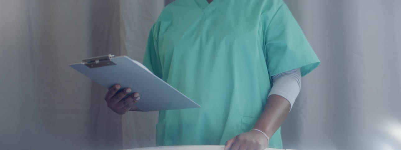 A doctor is holding a clipboard