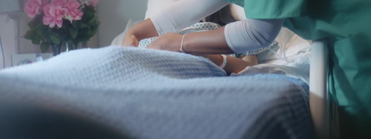 Static shot of a patient being tended to by a nurse