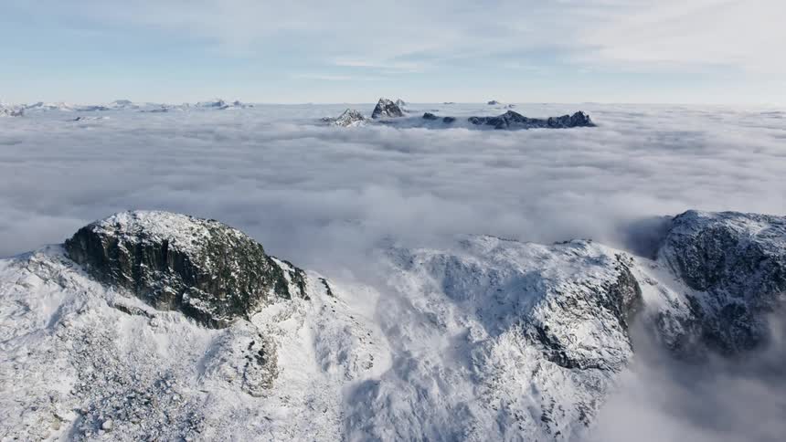 The sun shines on a snowy mountain range