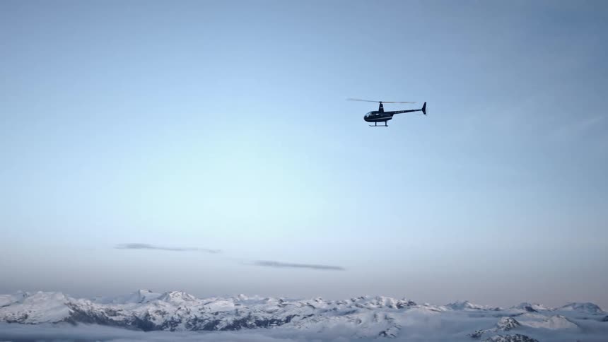 A helicopter is flying above an arctic area