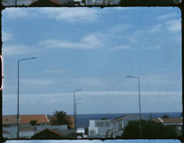 A neighborhood and street with house that overlook the ocean