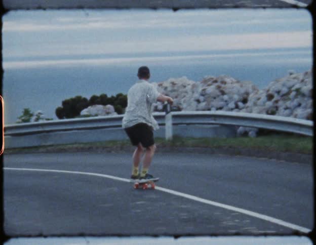 A man does a trick on a skateboard in a street