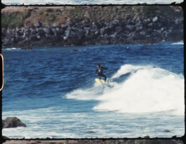 A man is surfing near the shore