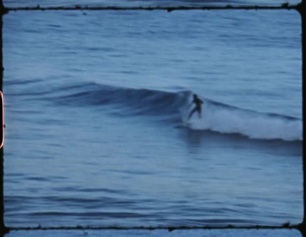 A person riding a wave in the ocean on a surfboard
