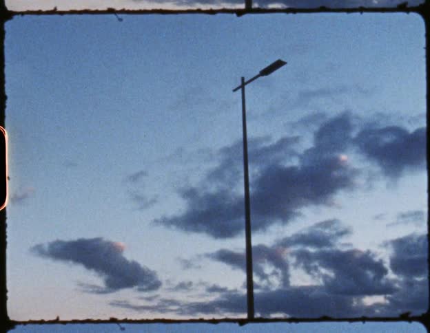 An old film with the moon hiding behind clouds