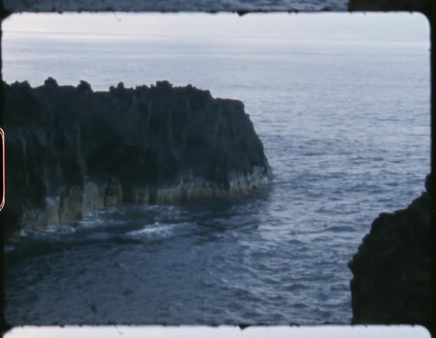 Ocean waves crash onto a rock face