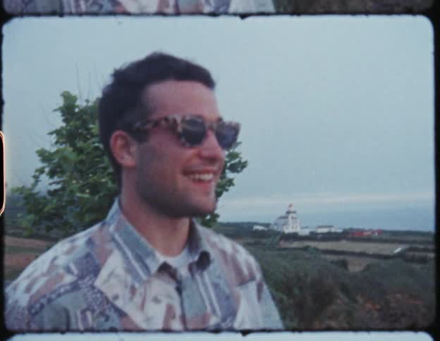 A film strip of man outside talking