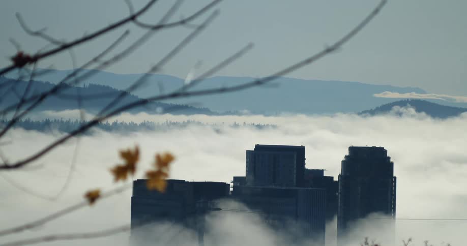 Time lapse of clouds passing over a city in a valley in the mountains